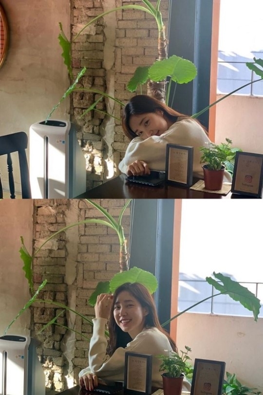 'Chee Hee' is sitting by the window of a cafe